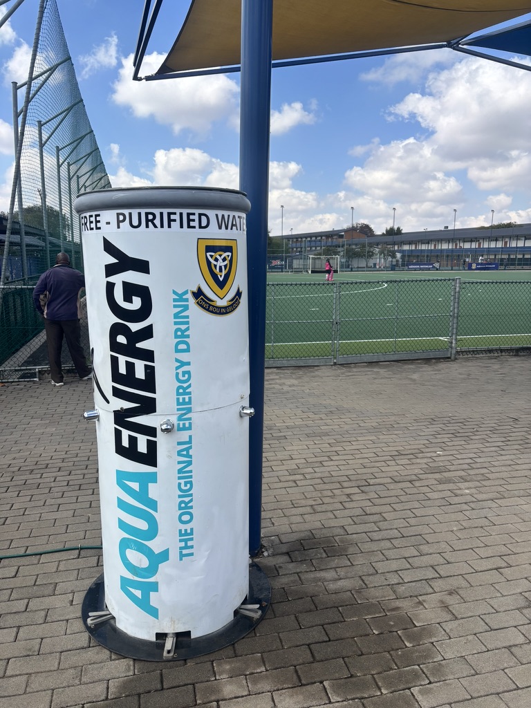 School-branded hydration station beside a sports field